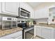 Kitchen with stainless steel appliances and granite countertops at 3782 Pine Cone Ln, Ormond Beach, FL 32174