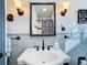 Bathroom with a pedestal sink, framed mirror, and black and white accents at 410 N Thorpe Ave, Orange City, FL 32763