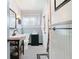 Clean bathroom, featuring a pedestal sink, black and white tile floor, and wainscoting at 410 N Thorpe Ave, Orange City, FL 32763