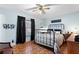 Main bedroom with ceiling fan, wood floors and a metal bed frame at 454 Ellsworth St, Altamonte Springs, FL 32701