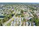 Aerial view of a residential area with numerous homes, trees, and a small lake at 4619 Barnacle Dr, Port Orange, FL 32127