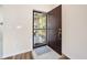 Interior view of an entryway with a brown door and a security door at 4619 Barnacle Dr, Port Orange, FL 32127