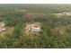 Aerial view showcasing house's wooded surroundings at 4666 Fir Rd, New Smyrna Beach, FL 32168