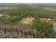 Aerial view of a house on a large lot with a barn and pond at 4666 Fir Rd, New Smyrna Beach, FL 32168