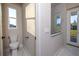 Bathroom with toilet, shower, and backyard access at 500 Whitecap Cove Ct, Debary, FL 32713