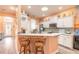 White kitchen with breakfast bar, stainless steel appliances, and light green tile backsplash at 821 Wingate Trl, Port Orange, FL 32128