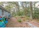 Fenced backyard with trees, play area, and gardening space at 855 E Church St, Deland, FL 32724