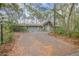 Quaint blue house with a brick driveway and lush landscaping at 855 E Church St, Deland, FL 32724