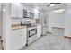 Stainless steel appliances and white cabinets in this galley kitchen at 955 W 9Th St, Deltona, FL 32725