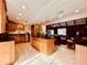 Spacious kitchen with island, granite countertops, and wooden cabinets at 110 W Washington Ave, Deland, FL 32720