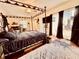 Large main bedroom with a canopy bed and access to a private patio at 110 W Washington Ave, Deland, FL 32720