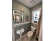 Updated bathroom with pedestal sink, toilet and a window at 1146 Riverside Dr, Daytona Beach, FL 32117