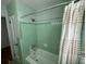 Retro bathroom with mint green tile, shower, and bathtub at 1146 Riverside Dr, Daytona Beach, FL 32117