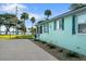 Side view of teal home showcasing landscaping and waterfront views at 1146 Riverside Dr, Daytona Beach, FL 32117
