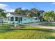 Front view of a teal house with a driveway and landscaping at 1146 Riverside Dr, Daytona Beach, FL 32117
