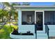 Screened porch entrance of a teal house with landscaping at 1146 Riverside Dr, Daytona Beach, FL 32117