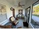 Cozy front porch with wicker chairs and screened enclosure at 1146 Riverside Dr, Daytona Beach, FL 32117