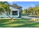 Charming light teal home with a well-manicured lawn and a large oak tree at 1146 Riverside Dr, Daytona Beach, FL 32117