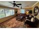 Spacious living room featuring a leather sofa, coffee table, and large windows at 1146 Riverside Dr, Daytona Beach, FL 32117