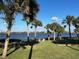 Peaceful waterfront view with palm trees and seating area at 1146 Riverside Dr, Daytona Beach, FL 32117