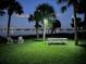 Night view of waterfront property with picnic table and chairs at 1146 Riverside Dr, Daytona Beach, FL 32117
