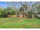 Spacious backyard with a wooden fence and mature trees at 1807 W 3Rd St, Sanford, FL 32771