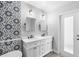 Double vanity bathroom with modern fixtures and a decorative tile at 216 Friesian Way, Sanford, FL 32773