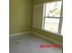 Empty bedroom with light green walls and plantation shutters at 2301 9Th Ave, Deland, FL 32724