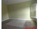 Spacious bedroom with large windows, green walls, and partially carpeted flooring at 2301 9Th Ave, Deland, FL 32724
