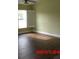 Spacious living room with green walls and wood-look tile floors at 2301 9Th Ave, Deland, FL 32724