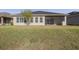 House showcasing a large backyard with a screened patio at 277 Cyan Ave, Daytona Beach, FL 32124