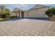 Large paver driveway leading to a two-car garage at 277 Cyan Ave, Daytona Beach, FL 32124