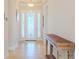 Bright entryway with tile flooring, wood console table, and glass-paned front door at 277 Cyan Ave, Daytona Beach, FL 32124