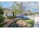 Landscaped front yard with a tree and paver driveway at 277 Cyan Ave, Daytona Beach, FL 32124
