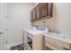 Laundry room with washer, dryer, cabinets, and utility sink at 277 Cyan Ave, Daytona Beach, FL 32124