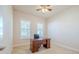 Spacious office with wood desk, chair, and large windows with shutters at 277 Cyan Ave, Daytona Beach, FL 32124