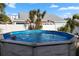 Inviting above ground pool with palm trees and spacious backyard at 3603 Surfside Ter, Port Orange, FL 32127