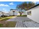 Brick patio, shed, and lush lawn in backyard at 3603 Surfside Ter, Port Orange, FL 32127