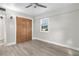Bedroom with wood-look floors, ceiling fan, and double doors leading to closet at 3603 Surfside Ter, Port Orange, FL 32127