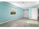 Bedroom with light blue walls, wood floors, and a closet at 3603 Surfside Ter, Port Orange, FL 32127