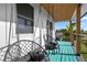Relaxing deck with teal painted floors and two hanging chairs at 3603 Surfside Ter, Port Orange, FL 32127