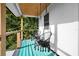 Relaxing deck with teal painted floors and two hanging chairs at 3603 Surfside Ter, Port Orange, FL 32127