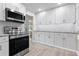 Modern kitchen with stainless steel appliances and white shaker cabinets at 3603 Surfside Ter, Port Orange, FL 32127