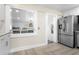 Open kitchen with breakfast bar and stainless steel refrigerator at 3603 Surfside Ter, Port Orange, FL 32127