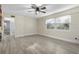 Spacious living room with light wood floors and a ceiling fan at 3603 Surfside Ter, Port Orange, FL 32127