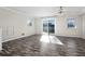 Spacious living room with wood-look floors, sliding doors, and ample natural light at 3603 Surfside Ter, Port Orange, FL 32127