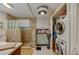Bathroom with a walk-in shower, vanity, and laundry area at 404 S Beach St # 010 101, Daytona Beach, FL 32114