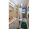 Bathroom with tiled shower and white vanity at 404 S Beach St # 010 101, Daytona Beach, FL 32114
