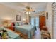 Bedroom with ceiling fan, and access to balcony at 404 S Beach St # 010 101, Daytona Beach, FL 32114