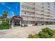 The Landmark building exterior with covered entryway and lush landscaping at 404 S Beach St # 010 101, Daytona Beach, FL 32114
